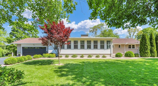 811 Hamilton Dr, Champaign, IL 61820 - ranch-style house featuring a front yard, an attached garage, and a chimney
