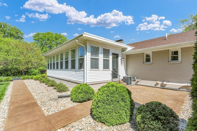 811 Hamilton Dr, Champaign, IL 61820 - rear view of house featuring central air condition unit, a patio, and brick siding