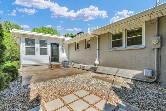 811 Hamilton Dr, Champaign, IL 61820 - entrance to property with a patio, cooling unit, and brick siding