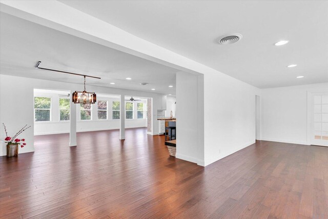 811 Hamilton Dr, Champaign, IL 61820 - unfurnished living room featuring recessed lighting, dark wood-type flooring, baseboards, a ceiling fan, and a chandelier