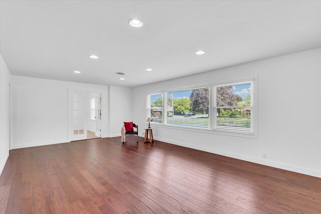 811 Hamilton Dr, Champaign, IL 61820 - unfurnished living room with dark wood finished floors, recessed lighting, and baseboards