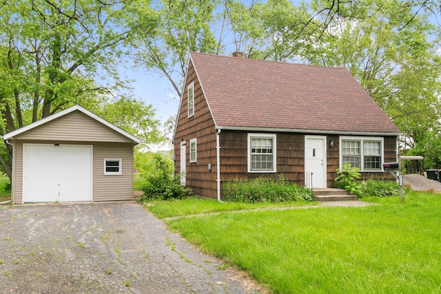 17725 Henry St, Lansing, IL 60438 - view of front of property with a detached garage, an outdoor structure, roof with shingles, a chimney, and driveway