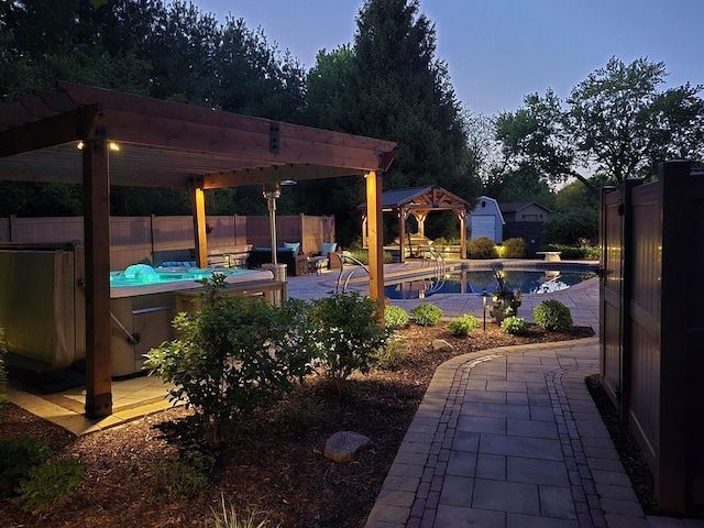 view of pool with a jacuzzi, a gazebo, fence, a patio area, and a pergola
