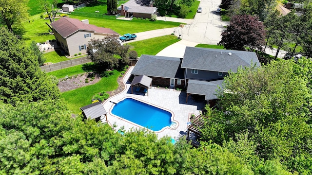 view of subject property with a pool