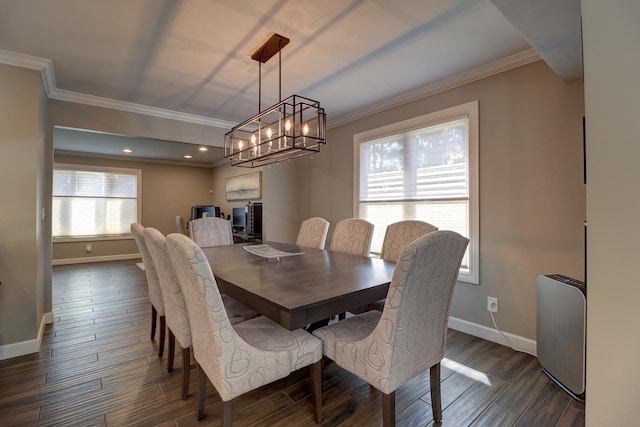 dining room featuring baseboards, dark wood-style floors, a chandelier, and ornamental molding