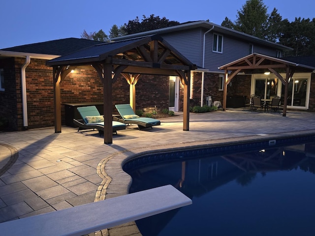 outdoor pool with a gazebo and a patio area