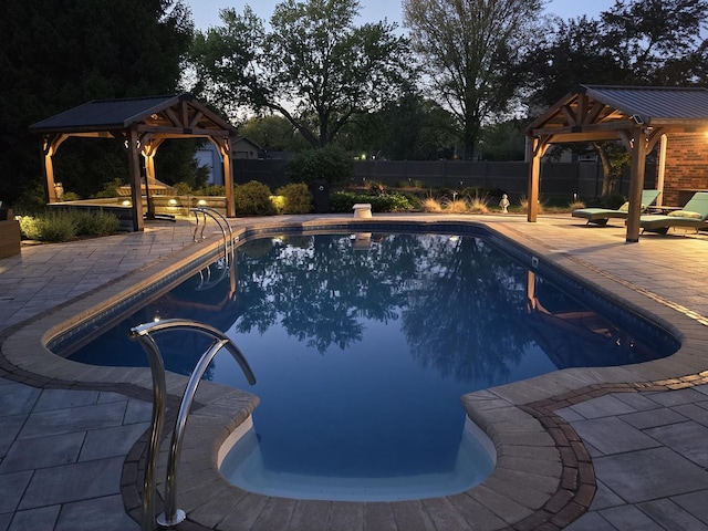 view of pool with a gazebo, a fenced backyard, and a patio