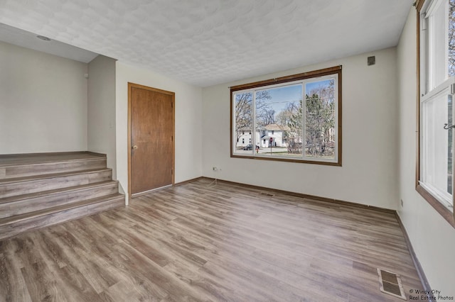 337 George Ave, Waukegan, IL 60085 - unfurnished room featuring wood finished floors, baseboards, and stairway