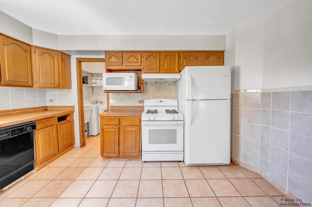 337 George Ave, Waukegan, IL 60085 - kitchen featuring white appliances, under cabinet range hood, tile walls, light countertops, and light tile patterned floors