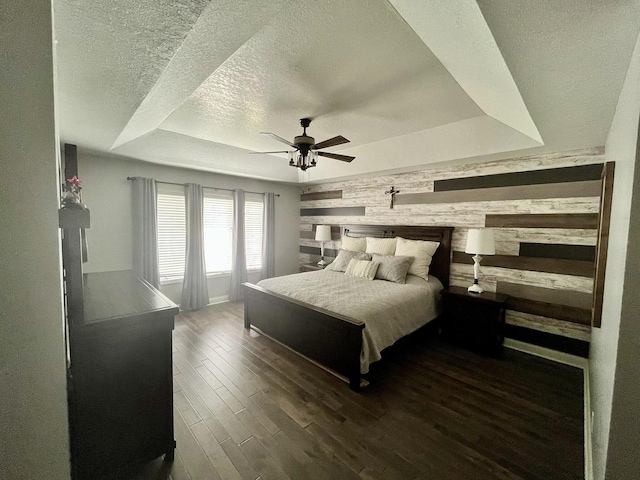 1143 N Westshore Blvd, Manteno, IL 60950 - bedroom featuring wood walls, a textured ceiling, a raised ceiling, wood finished floors, and a ceiling fan