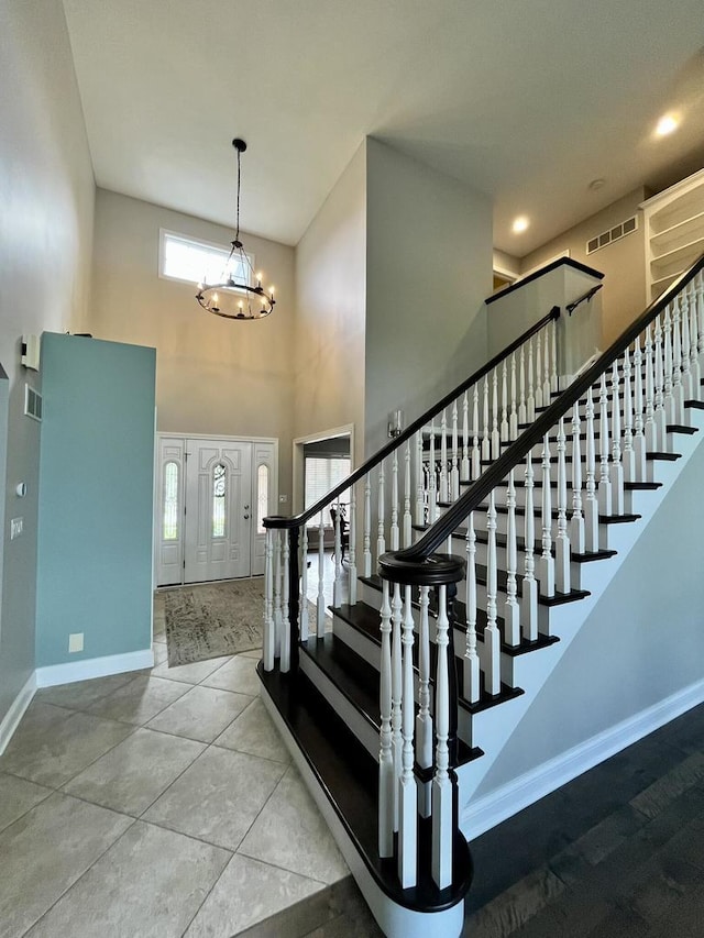 1143 N Westshore Blvd, Manteno, IL 60950 - entryway featuring baseboards, a towering ceiling, stairs, and a chandelier