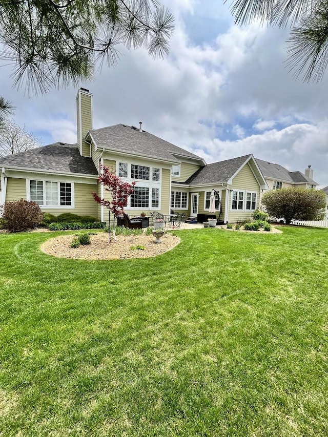 1143 N Westshore Blvd, Manteno, IL 60950 - back of property with a patio, a yard, and a chimney