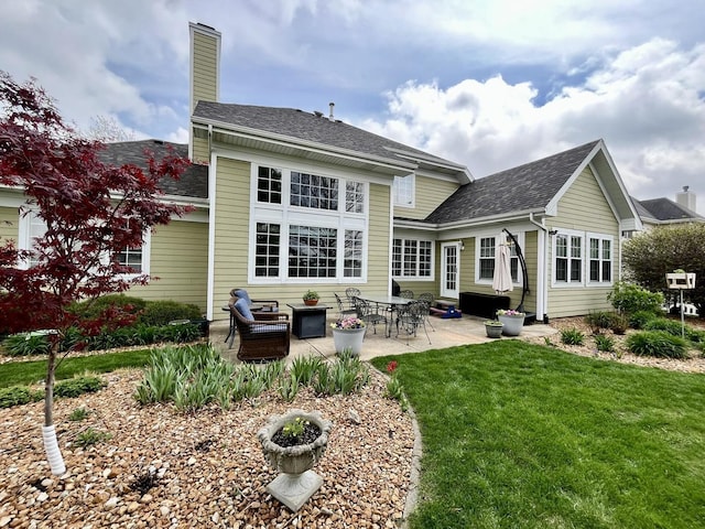 1143 N Westshore Blvd, Manteno, IL 60950 - rear view of house featuring a lawn, a patio area, a chimney, and a shingled roof