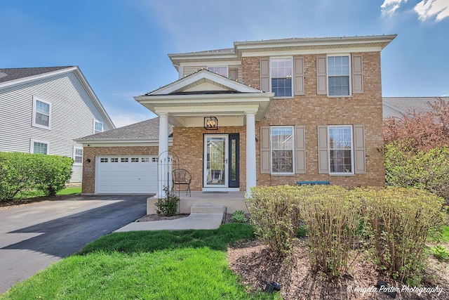 3123 Concord Ln, Wadsworth, IL 60083 - view of front facade featuring brick siding, driveway, and a garage