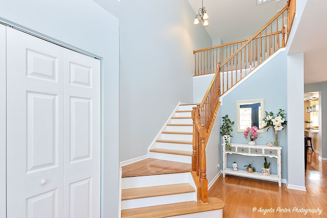 3123 Concord Ln, Wadsworth, IL 60083 - staircase featuring high vaulted ceiling, wood finished floors, and baseboards