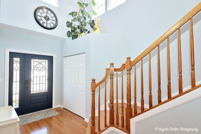3123 Concord Ln, Wadsworth, IL 60083 - foyer with hardwood / wood-style flooring, plenty of natural light, stairway, a high ceiling, and baseboards
