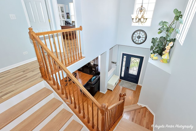 3123 Concord Ln, Wadsworth, IL 60083 - entryway featuring wood finished floors, a chandelier, baseboards, a towering ceiling, and stairway