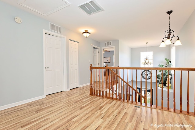 3123 Concord Ln, Wadsworth, IL 60083 - hallway featuring an upstairs landing, wood finished floors, a chandelier, and baseboards