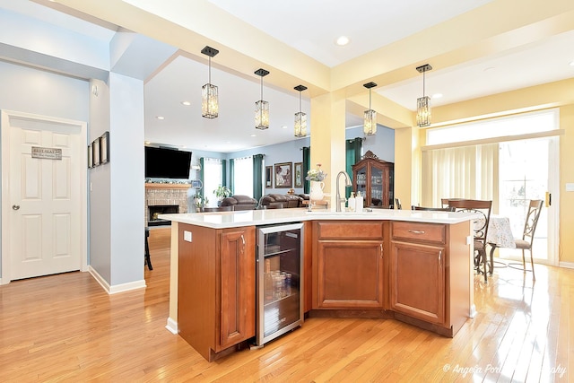 3123 Concord Ln, Wadsworth, IL 60083 - kitchen featuring beverage cooler, a sink, light wood-style floors, light countertops, and recessed lighting