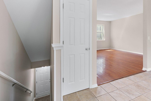 stairway featuring tile patterned floors and baseboards