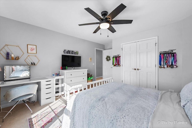carpeted bedroom with a closet and a ceiling fan