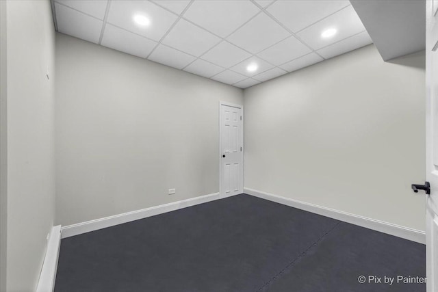 spare room featuring baseboards, recessed lighting, and a drop ceiling