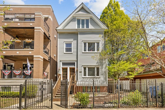 3809 N Kenmore Ave, Chicago, IL 60613 - townhome / multi-family property featuring a balcony, a fenced front yard, and a gate