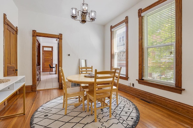 3809 N Kenmore Ave, Chicago, IL 60613 - dining room with light wood finished floors and a chandelier