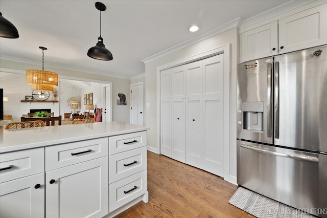 20 S Cambridge Dr, Geneva, IL 60134 - kitchen featuring stainless steel fridge with ice dispenser, crown molding, a fireplace, light wood-type flooring, and pendant lighting