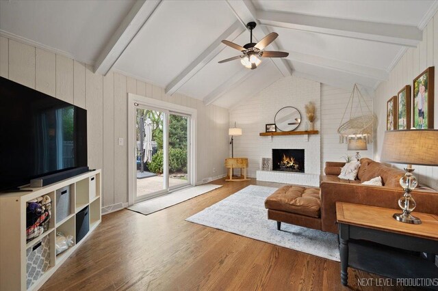 20 S Cambridge Dr, Geneva, IL 60134 - living room with wood finished floors, a ceiling fan, a brick fireplace, and wooden walls