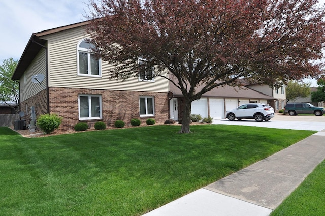 815 Meadow Rdg Unit 2, New Lenox, IL 60451 - view of front of home featuring brick siding, driveway, a front yard, central AC, and an attached garage