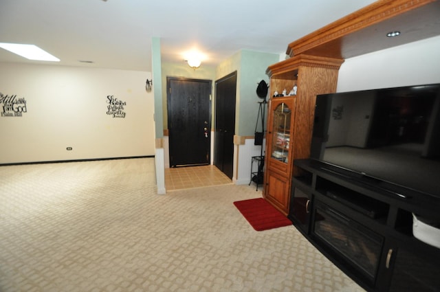 815 Meadow Rdg Unit 2, New Lenox, IL 60451 - living room with light colored carpet, baseboards, and a skylight