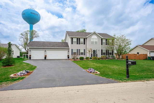 colonial home featuring a garage and driveway