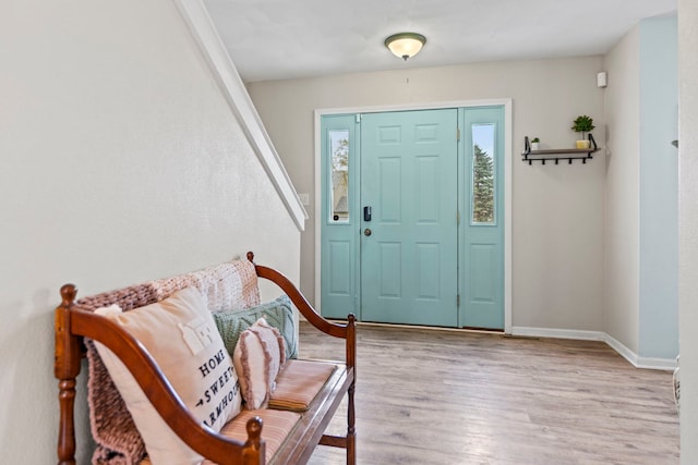 entrance foyer featuring wood finished floors and baseboards