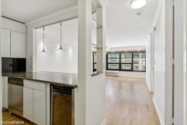 30 E Huron St Unit 1110, Chicago, IL 60611 - kitchen featuring beverage cooler, ornamental molding, dark countertops, white cabinets, and light wood-style flooring