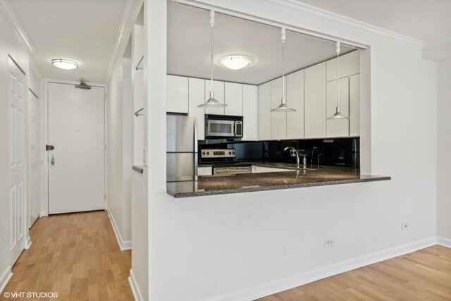 30 E Huron St Unit 1110, Chicago, IL 60611 - kitchen featuring stainless steel appliances, light wood-style floors, a sink, white cabinetry, and ornamental molding