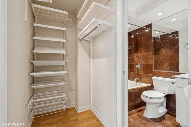 30 E Huron St Unit 1110, Chicago, IL 60611 - full bathroom with toilet, tiled shower / bath combo, recessed lighting, vanity, and wood finished floors