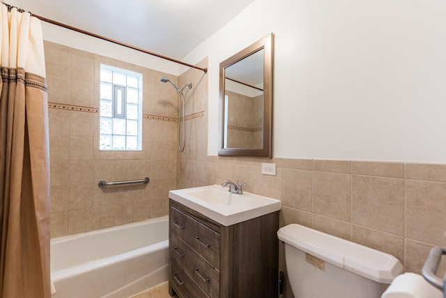 bathroom with toilet, tile walls, shower / bath combination with curtain, and vanity
