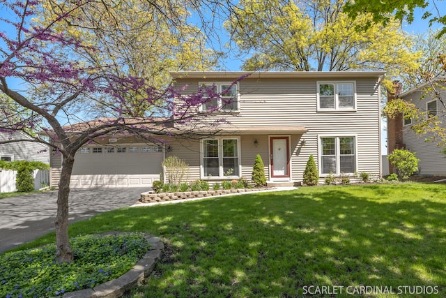 traditional-style house featuring a front lawn, an attached garage, and driveway