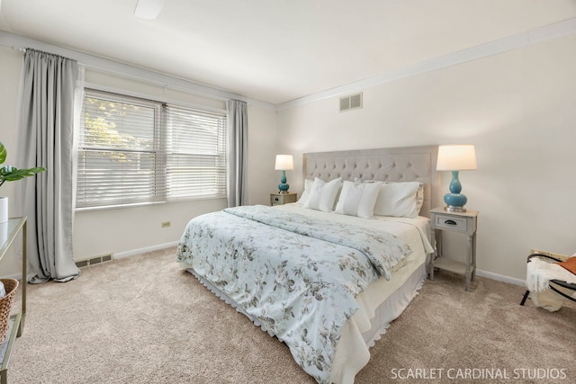 bedroom with carpet flooring, baseboards, and crown molding