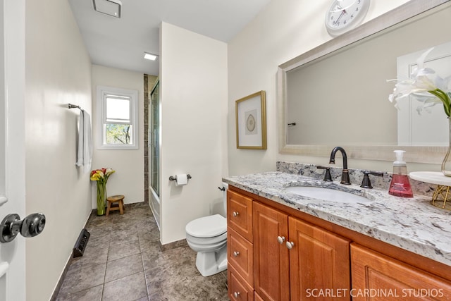 bathroom with toilet, vanity, enclosed tub / shower combo, and baseboards