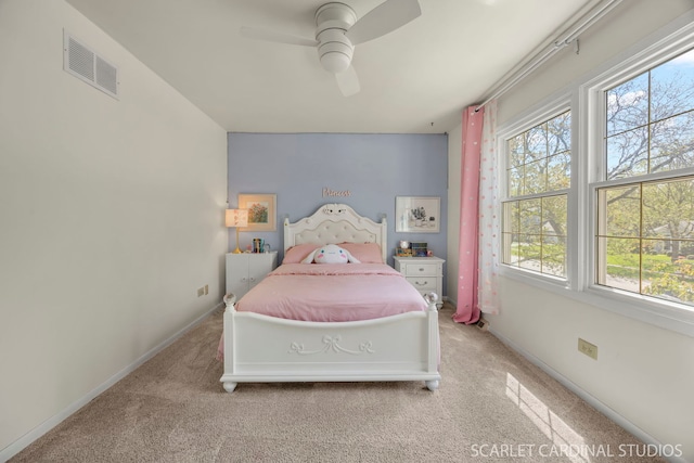 bedroom featuring carpet, multiple windows, baseboards, and ceiling fan