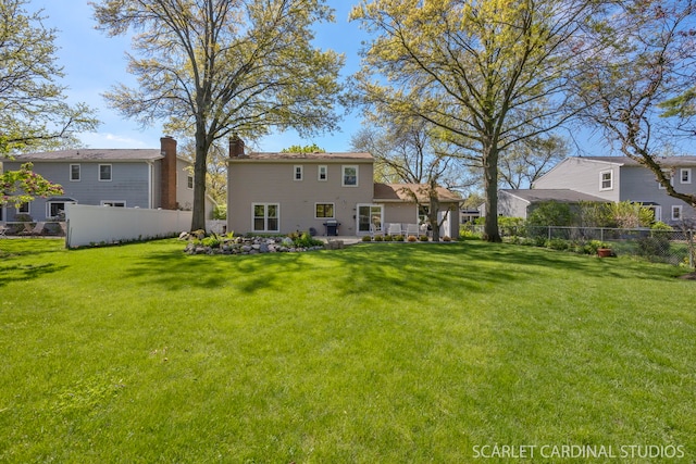 back of property featuring a patio and a chimney