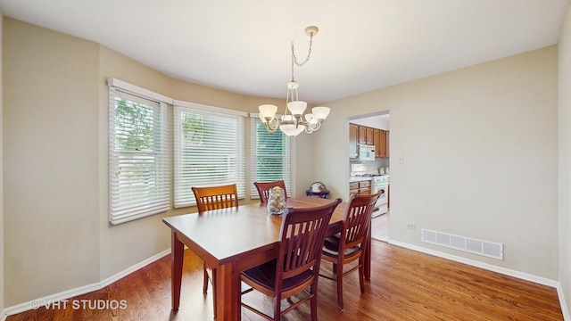 190 Washo Ct, Lake Zurich, IL 60047 - dining space featuring a chandelier, baseboards, and light wood-type flooring