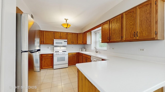 190 Washo Ct, Lake Zurich, IL 60047 - kitchen featuring white appliances, a sink, brown cabinetry, light countertops, and light tile patterned floors