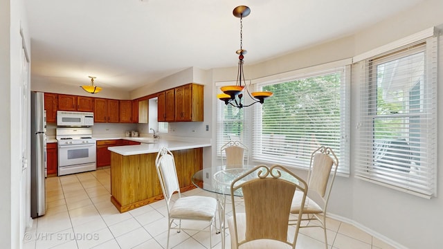 190 Washo Ct, Lake Zurich, IL 60047 - kitchen featuring white appliances, a sink, a peninsula, light countertops, and light tile patterned floors