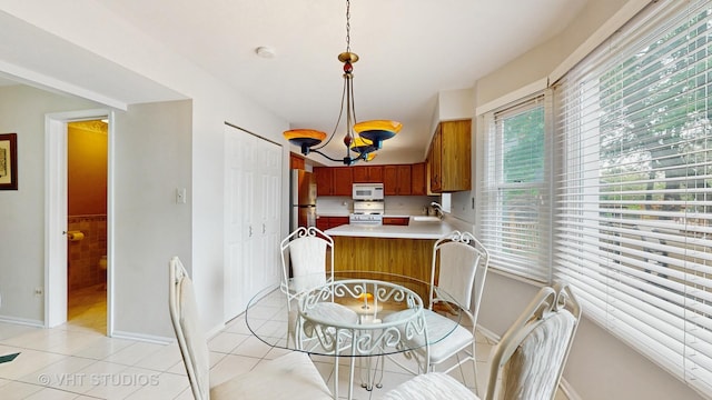 190 Washo Ct, Lake Zurich, IL 60047 - dining area with light tile patterned flooring, a chandelier, and baseboards