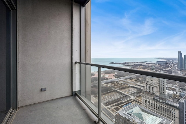 balcony featuring a view of city and a water view
