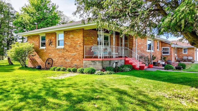 2651 E 2900 N Rd, Ancona, IL 61311 - view of front of home featuring brick siding, covered porch, and a front yard