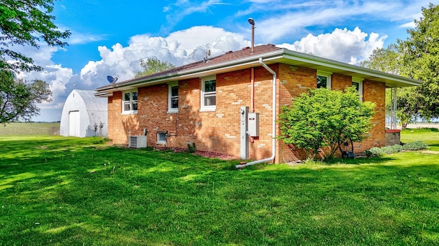2651 E 2900 N Rd, Ancona, IL 61311 - back of property featuring a yard, brick siding, and cooling unit